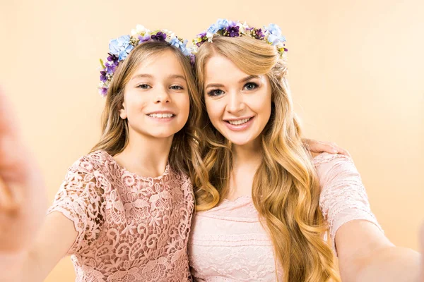 Foco seletivo de mãe bonita e filha adorável sorrindo e olhando para a câmera no fundo amarelo — Fotografia de Stock