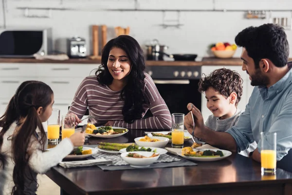 Cheerful hispanic family having lunch at home — Stock Photo