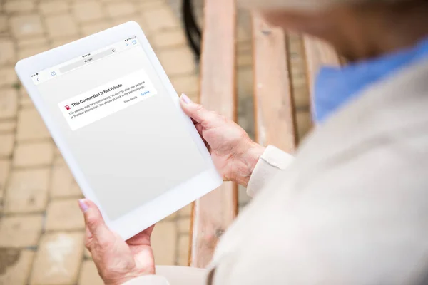 Selective focus of woman using digital tablet with vk website on screen — Stock Photo