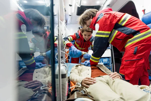 Paramedics doing cardiopulmonary resuscitation in ambulance car — Stock Photo