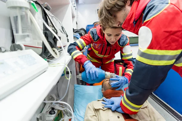 Les ambulanciers en gants de latex font de la réanimation cardiopulmonaire — Photo de stock
