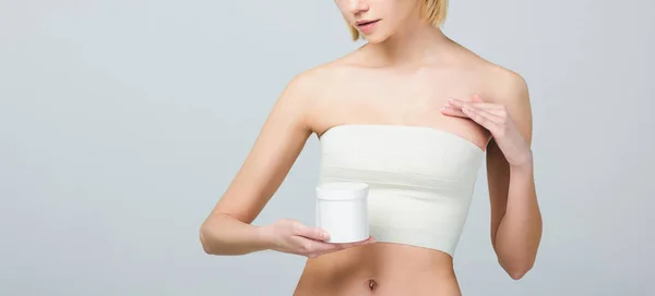 Cropped view of girl in breast bandage after plastic surgery holding plastic container with medicines, isolated on grey — Stock Photo