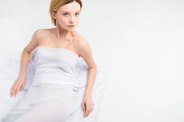 Blonde nude girl lying in white veil, isolated on grey — Stock Photo