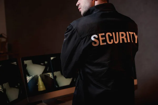 Cropped view of guard in black uniform at workspace — Stock Photo