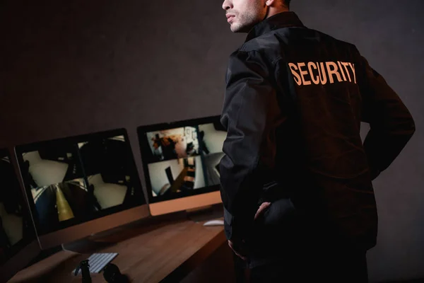 Partial view of guard in black uniform at workplace — Stock Photo