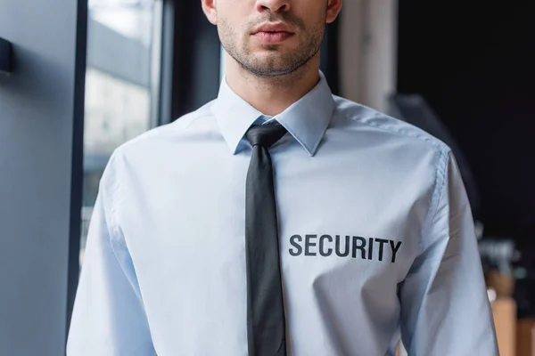 Cropped view of handsome guard in white shirt — Stock Photo