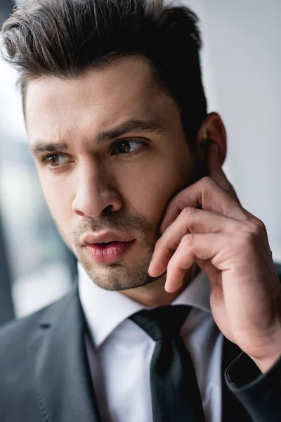 Primer plano de guardaespaldas guapo usando auriculares - foto de stock