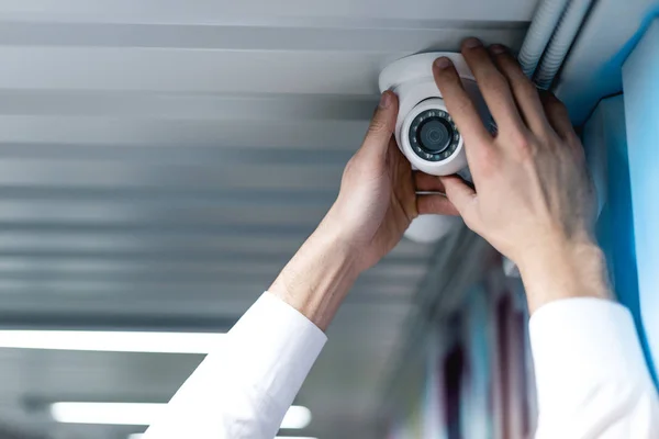 Partial view of man setting up security camera — Stock Photo