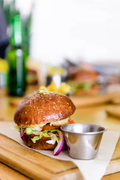 Selective focus of burger on cutting board with copy space — Stock Photo