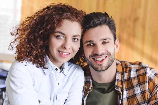Beautiful man and woman smiling and looking at camera — Stock Photo