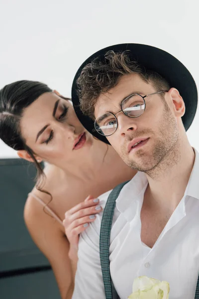 Selective focus on beautiful girl touching shoulder of handsome man in glasses — Stock Photo