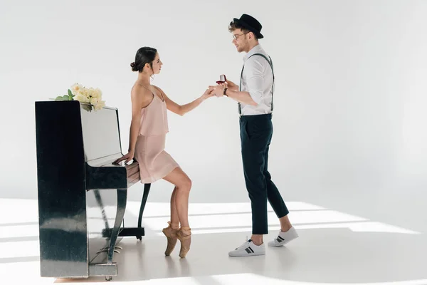 Handsome musician making marriage proposal to beautiful ballerina — Stock Photo