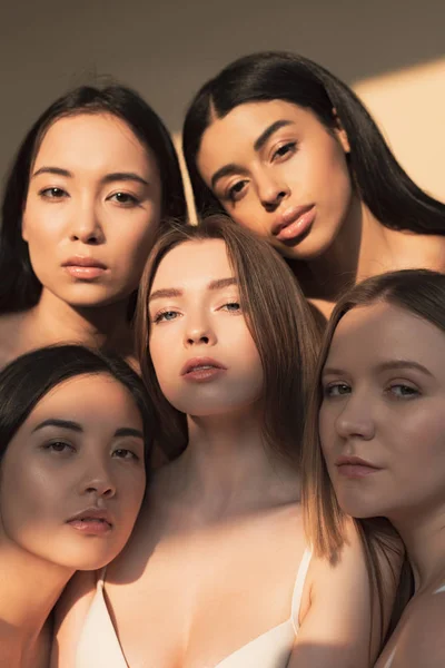 Five attractive multicultural young women looking at camera in sunlight — Stock Photo