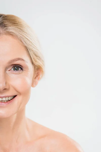 Partial view of smiling mature woman looking at camera isolated on grey — Stock Photo