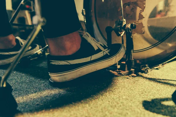 Cropped view of man in sneakers pressing bass pedal — Stock Photo