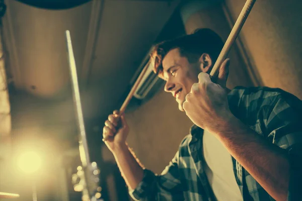 Drum sticks in hands on cheerful young drummer — Stock Photo