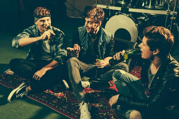 Overhead view of cheerful friends talking while drinking beer — Stock Photo