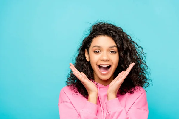 Excited curly african american girl screaming while standing isolated on blue — Stock Photo