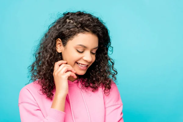 Happy curly african american girl smiling isolated on blue — Stock Photo