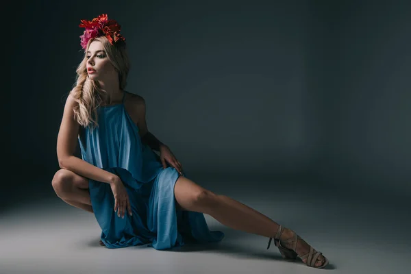 Beautiful and blonde woman in elegant dress and wreath looking away — Stock Photo