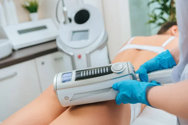 Partial view of cosmetologist doing  therapy for buttocks — Stock Photo