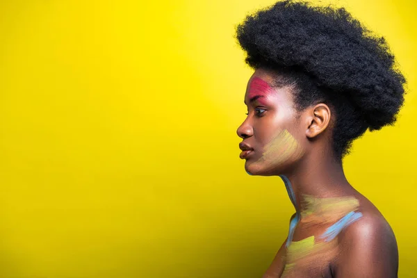 Вид збоку красивої афроамериканської жінки на жовтому — стокове фото
