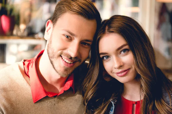 Happy bearded man and attractive young woman looking at camera — Stock Photo