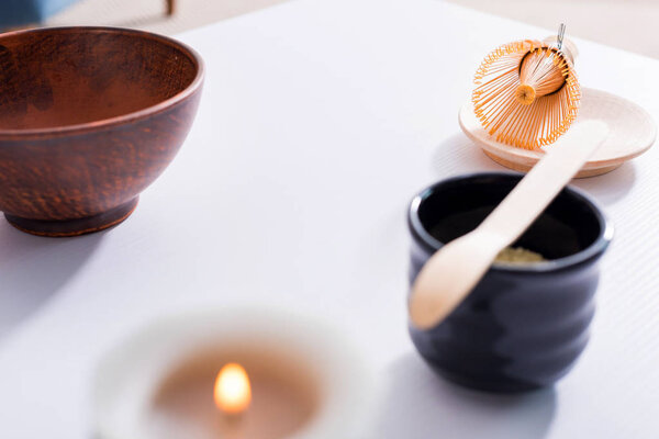 close up view of arranged ceramic cutlery for tea ceremony on white tabletop