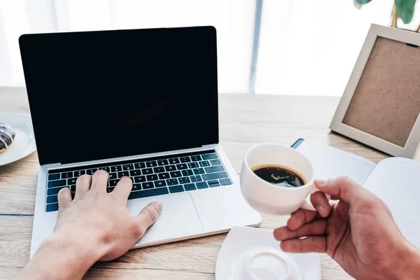 Partial View Man Holding Cup Coffee Typing Laptop Table Textbook — Stock Photo, Image