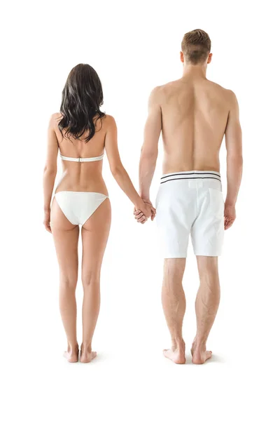 年轻夫妇在泳装牵手的背部视图 在白色隔离 — 图库照片
