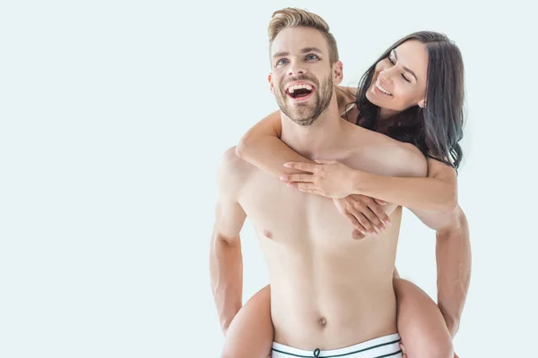 Young Laughing Man Piggybacking His Beautiful Girlfriend Isolated White — Stock Photo, Image