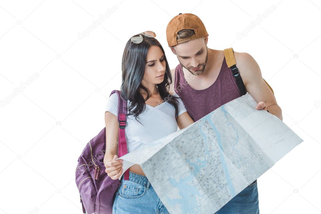 two travelers with backpacks looking at map, isolated on white