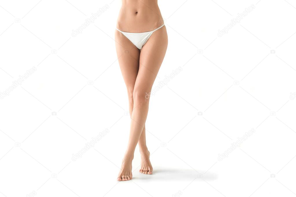 cropped view of young slim woman posing in white bikini, isolated on white