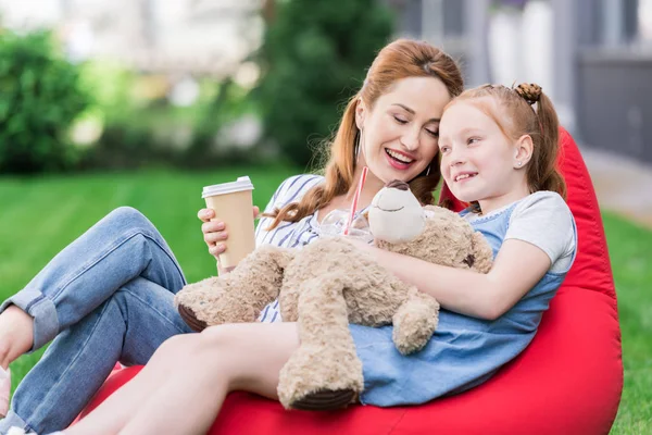 Smiling Mother Coffee Daughter Teddy Bear Resting Bean Bag Chair — Stock Photo, Image