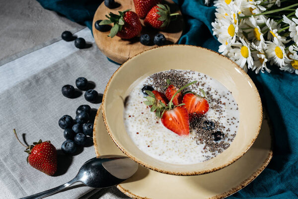 Chia seeds bowl for breakfast with fresh berries