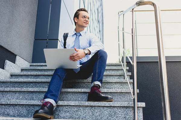 Low Angle View Handsome Young Businessman Eyeglasses Sitting Stairs Using — Free Stock Photo