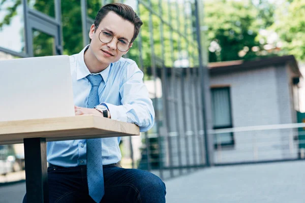 Bello Giovane Uomo Affari Occhiali Vista Utilizzando Computer Portatile Mentre — Foto stock gratuita