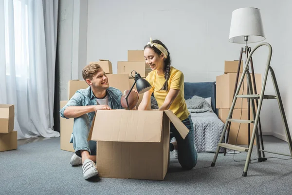 Interracial Young Couple Unpacking Boxes While Moving New Home — Stock Photo, Image