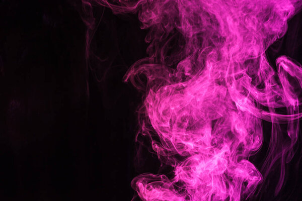 Mystical pink smoke on black background