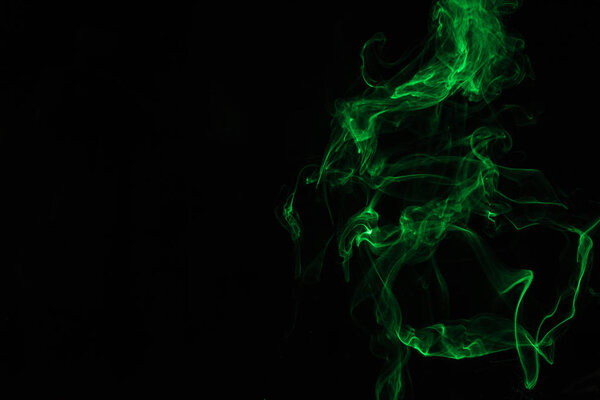 green smoke on black background with copy space