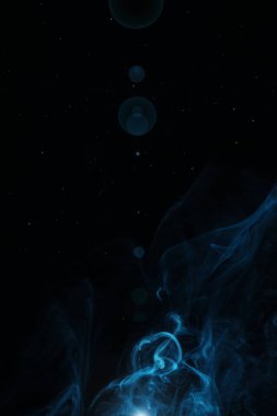 blue swirl smoke with light on black background with copy space clipart