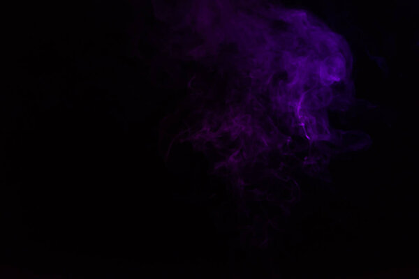 Mystical black background with purple smoke