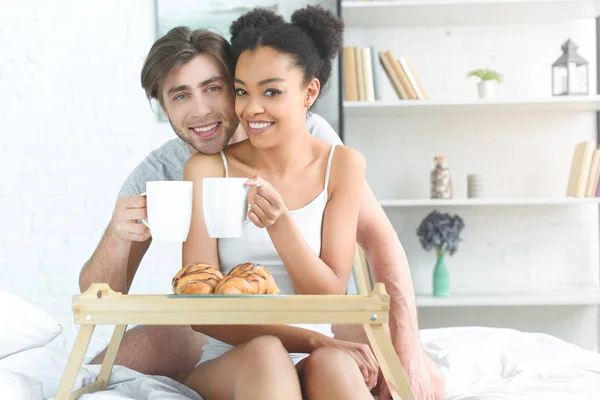 Portrait Multiracial Young Couple Cups Coffee Having Breakfast Bed Morning — Stock Photo, Image