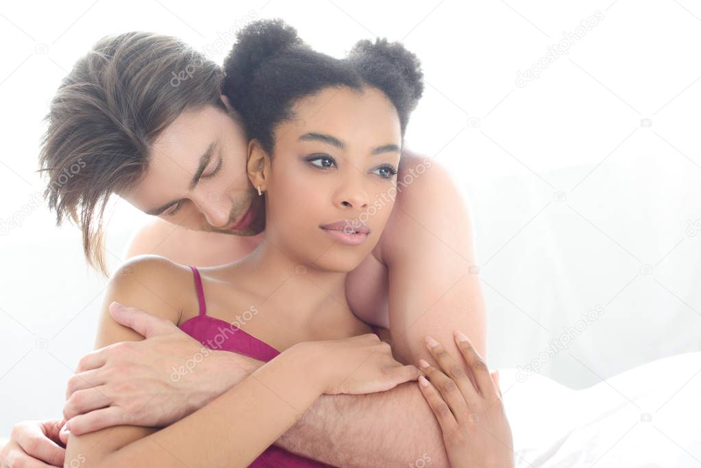 portrait of tender multiethnic couple in love at home