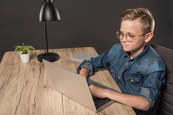 Schoolboy Eyeglasses Doing Homework Laptop Table Book Lamp Potted Plant — Stock Photo, Image