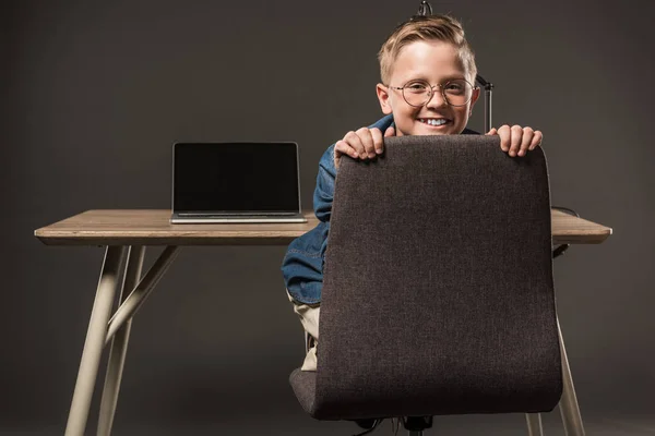 Happy Little Boy Sitting Chair Looking Camera Table Lamp Laptop — Stock Photo, Image