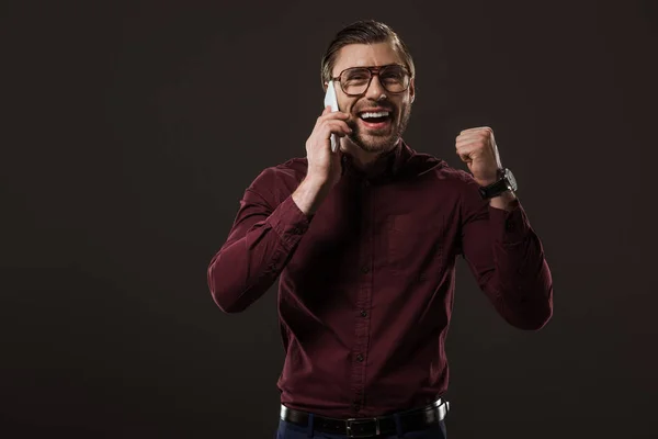 Cheerful Man Eyeglasses Talking Smartphone Triumphing Isolated Black — Stock Photo, Image
