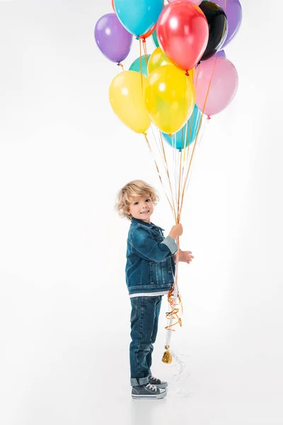 smiling adorable boy with bundle of balloons isolated on white