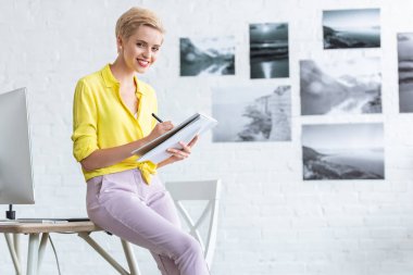 gülümseyen kadın freelancer ders kitabı evde bilgisayar masasi yakınındaki office yazma 