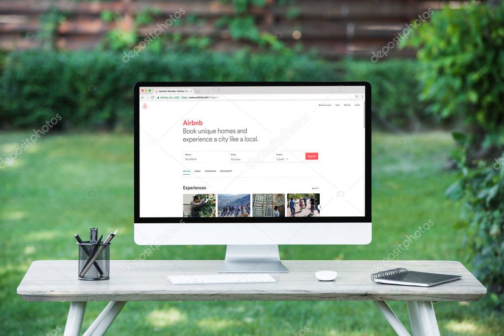 Selective focus of computer with airbnb website at table outdoors